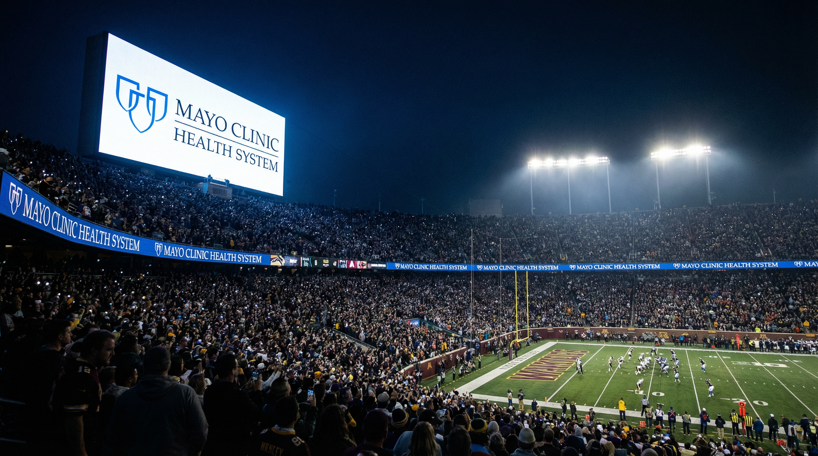 Health system logo displayed on stadium scoreboard during NFL game